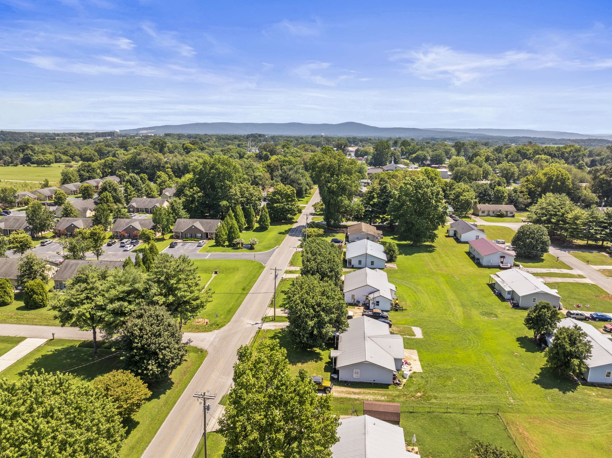 1101 Cumberland Street Decherd, TN 37324 - Photo 4 of 9 an aerial view of residential houses with outdoor space and trees all around