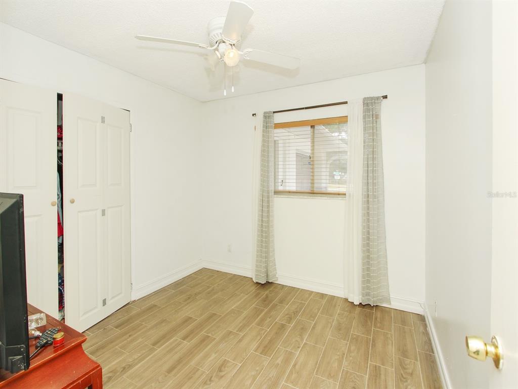 4173 Signal Hill Road Orlando, FL 32808 - Photo 16 of 22 a view of empty room with wooden floor