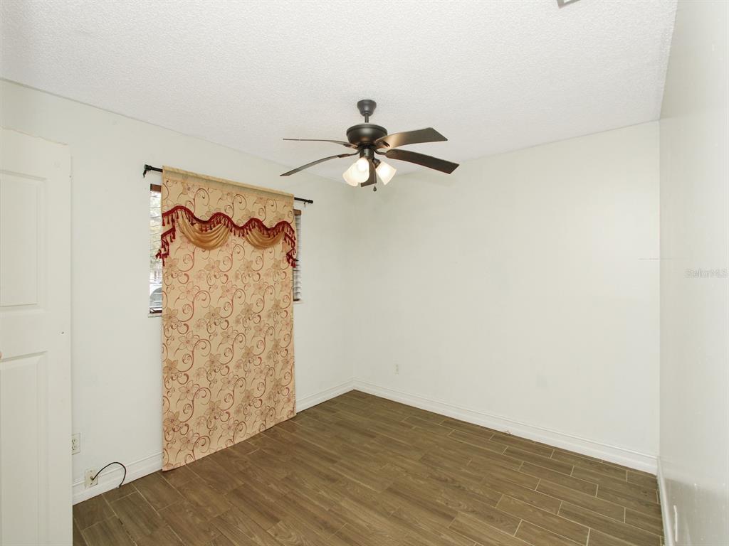 4173 Signal Hill Road Orlando, FL 32808 - Photo 18 of 22 a view of empty room with wooden floor
