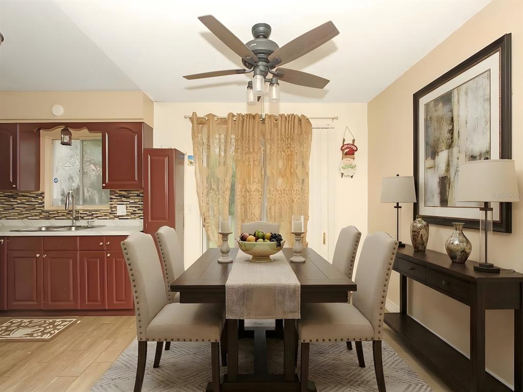 4173 Signal Hill Road Orlando, FL 32808 - Photo 5 of 22 a view of a a dining room with furniture window and wooden floor