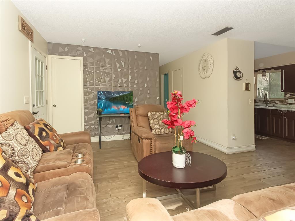 4173 Signal Hill Road Orlando, FL 32808 - Photo 7 of 22 a living room with furniture and a fireplace