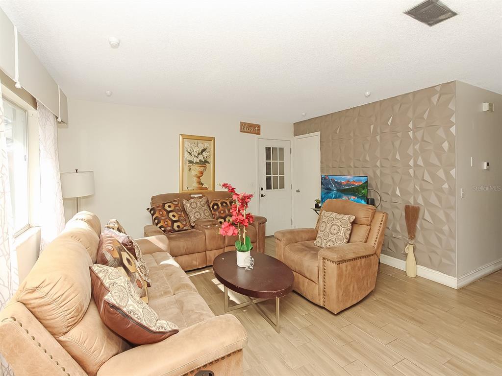 4173 Signal Hill Road Orlando, FL 32808 - Photo 8 of 22 a living room with furniture and wooden floor