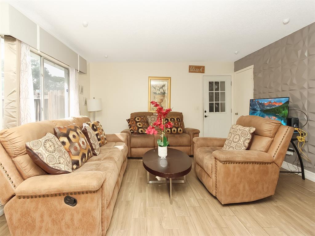 4173 Signal Hill Road Orlando, FL 32808 - Photo 9 of 22 a living room with furniture and a large window