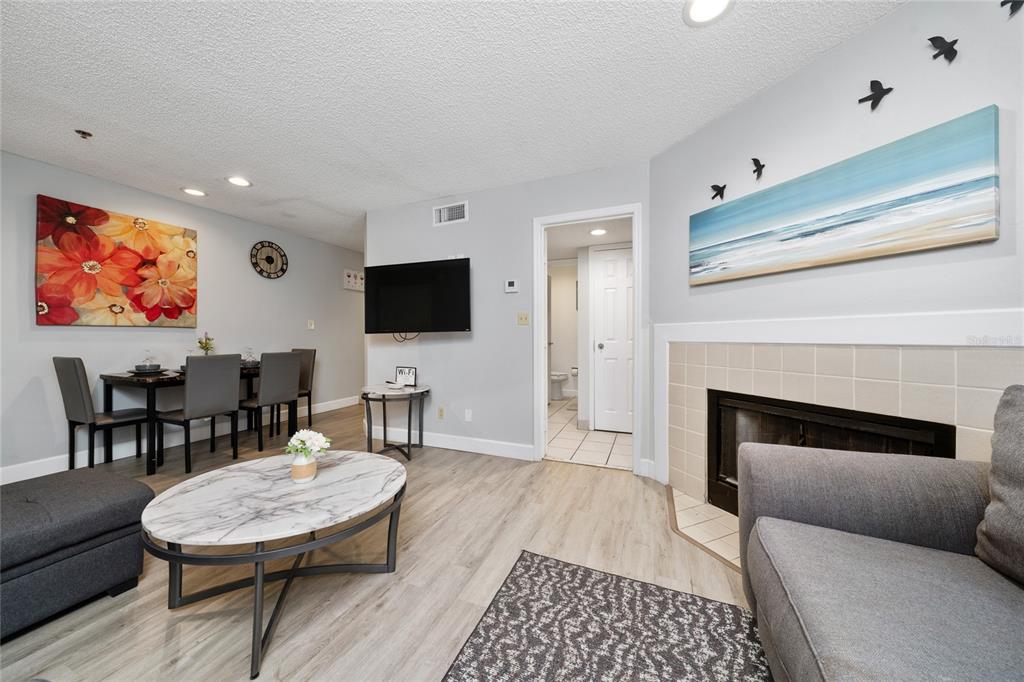 3100 Parkway Boulevard, Unit 511 Kissimmee, FL 34747 - Photo 15 of 40 a living room with furniture a fireplace and a flat screen tv