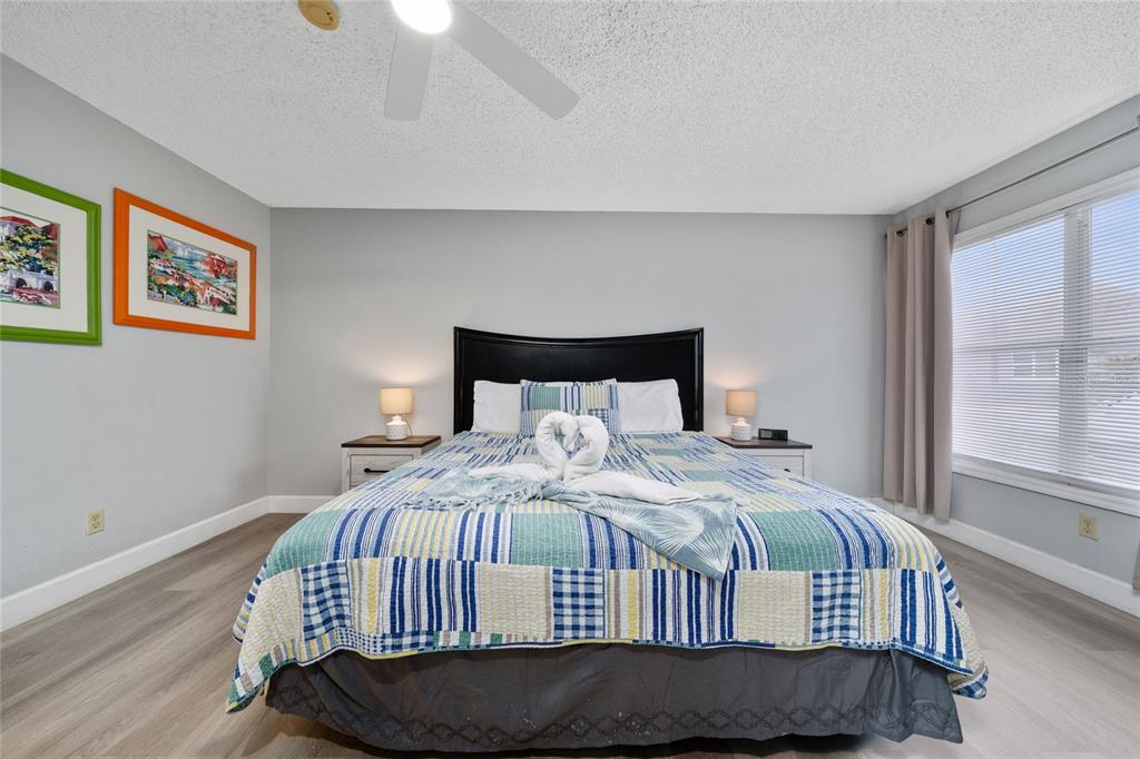 3100 Parkway Boulevard, Unit 511 Kissimmee, FL 34747 - Photo 17 of 40 a bedroom with a bed and wooden floor