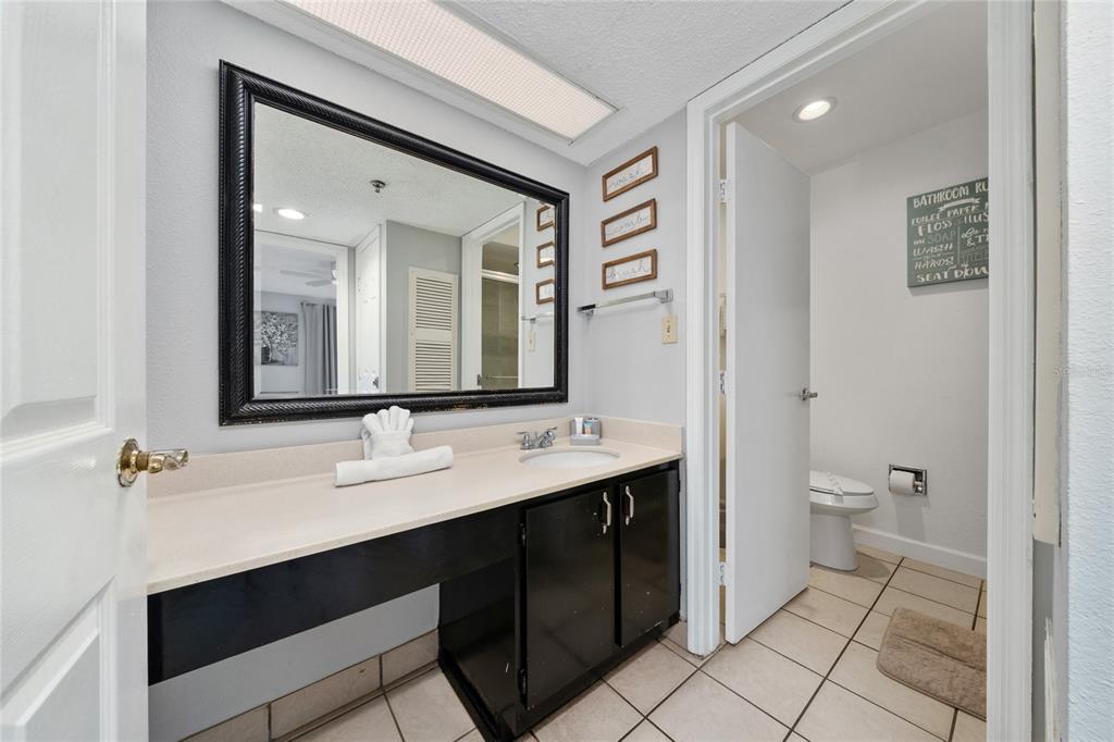 3100 Parkway Boulevard, Unit 511 Kissimmee, FL 34747 - Photo 21 of 40 a bathroom with a double vanity sink a mirror and a toilet
