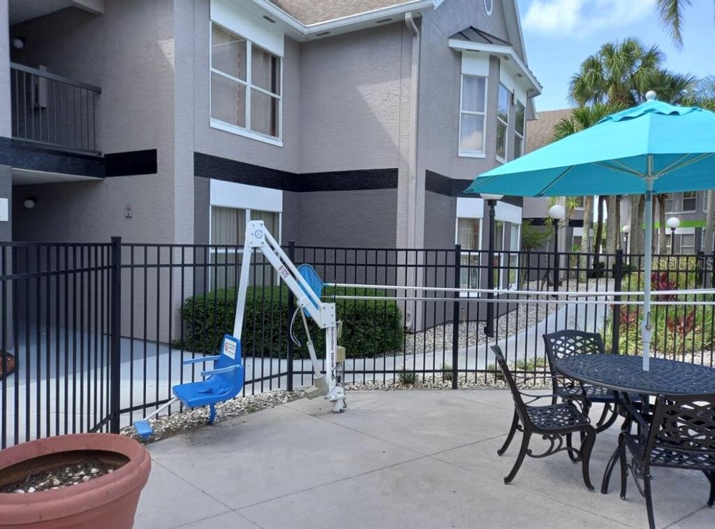 3100 Parkway Boulevard, Unit 511 Kissimmee, FL 34747 - Photo 27 of 40 a view of a patio with a table and chairs