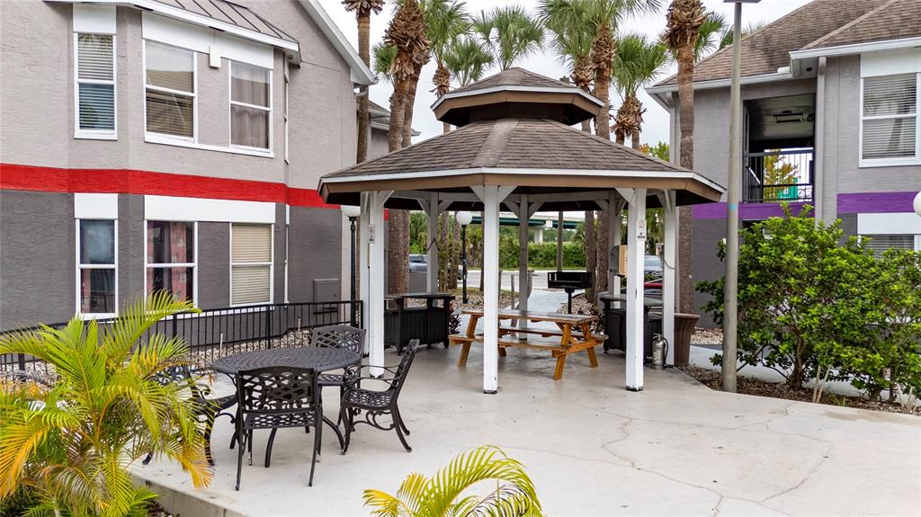 3100 Parkway Boulevard, Unit 511 Kissimmee, FL 34747 - Photo 37 of 40 a view of a patio with table and chairs under an umbrella