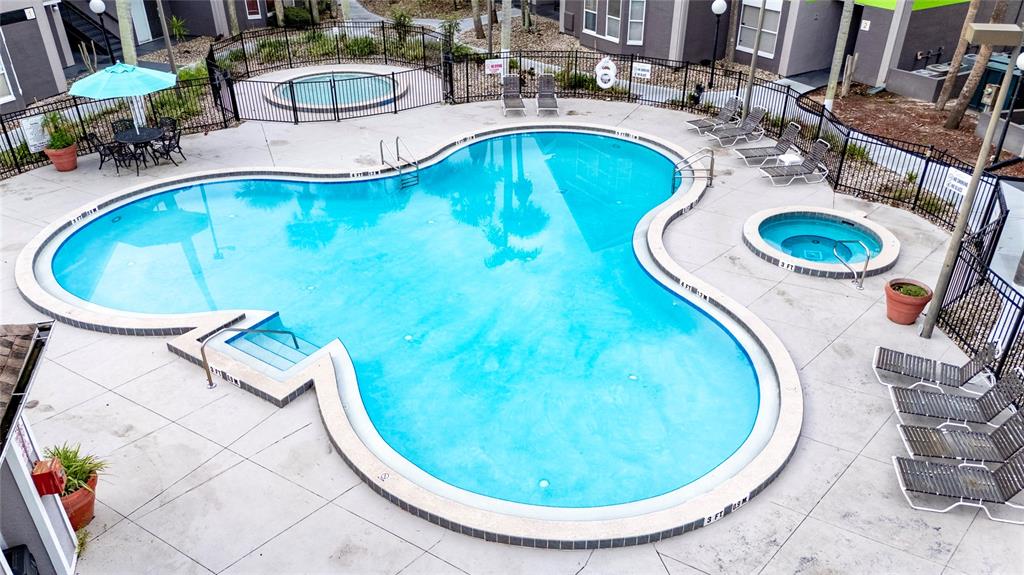 3100 Parkway Boulevard, Unit 511 Kissimmee, FL 34747 - Photo 38 of 40 an aerial view of a swimming pool with outdoor seating