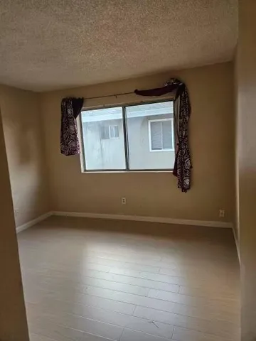 a bedroom with a bed and a potted plant