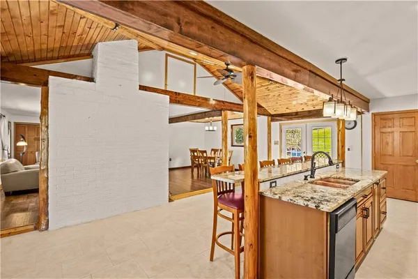 a view of living room kitchen with granite countertop stove and sink