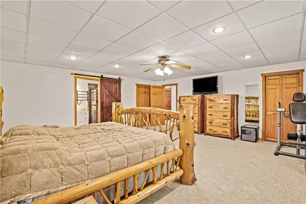 a bedroom with bed and glass door