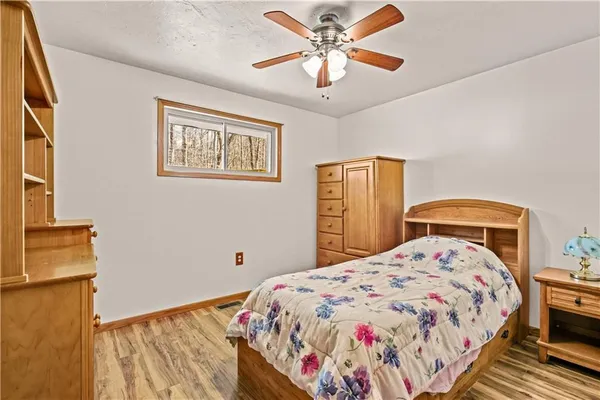 a bedroom with a bed and a cabinet