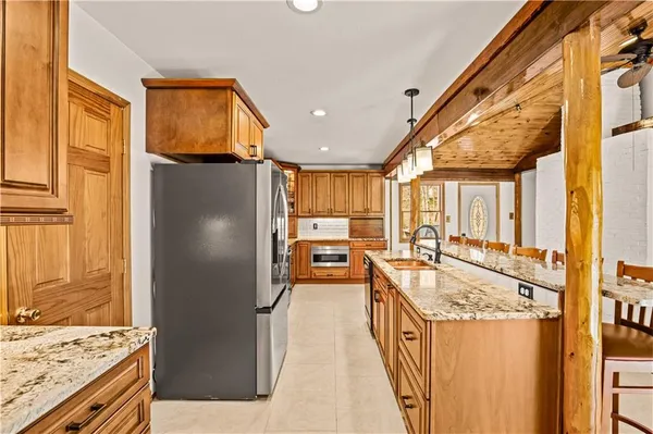 a kitchen with granite countertop a refrigerator and a stove