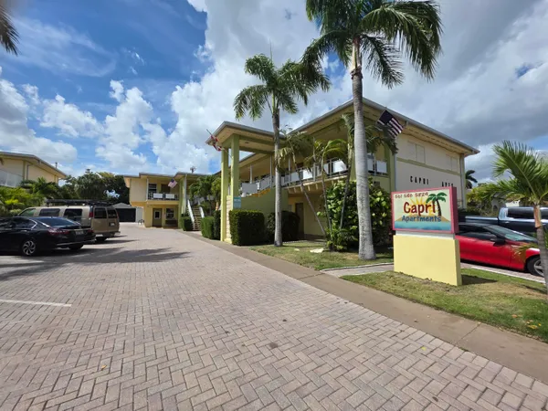 a palm tree sitting in front of a building
