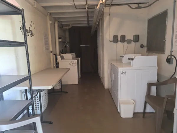 a view of a hallway with furniture and entryway