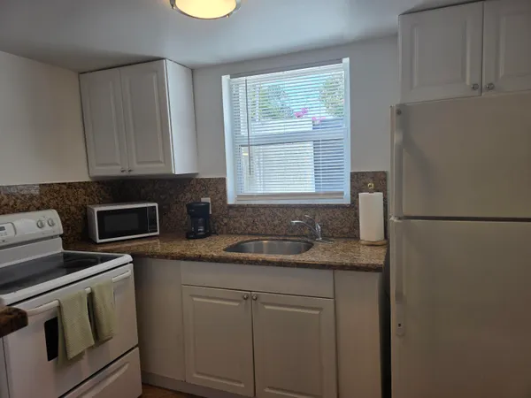 a kitchen with appliances cabinets and a counter top space