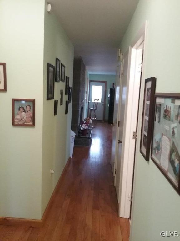 135 Longley Road Nazareth, PA 18064 - Photo 12 of 35 a hallway with wooden floor windows and a livingroom