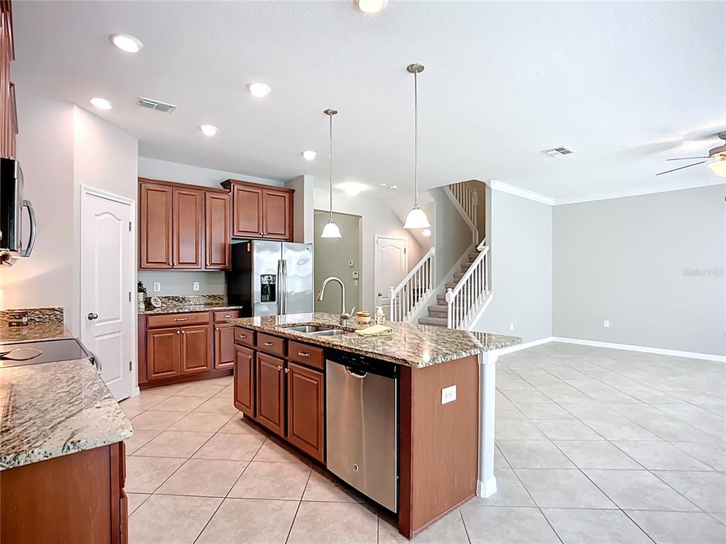 14240 Blue Dasher Drive Riverview, FL 33569 - Photo 23 of 66 a kitchen with stainless steel appliances granite countertop a stove a sink and a refrigerator