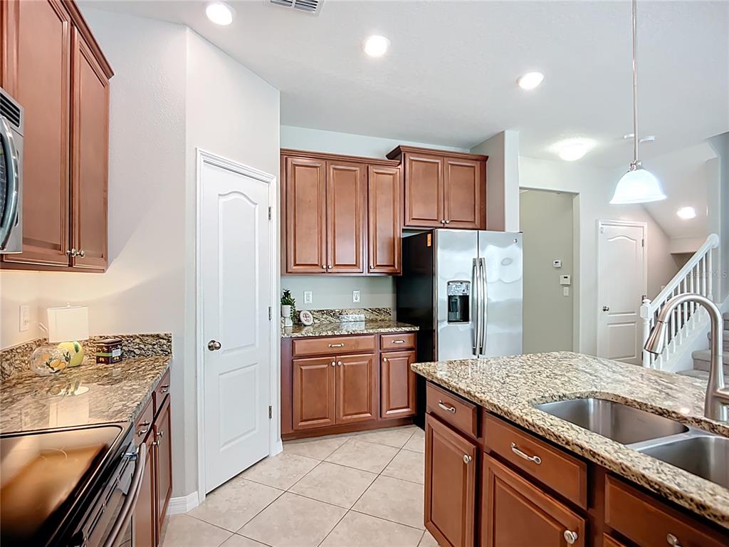 14240 Blue Dasher Drive Riverview, FL 33569 - Photo 25 of 66 a kitchen with a sink stove and refrigerator