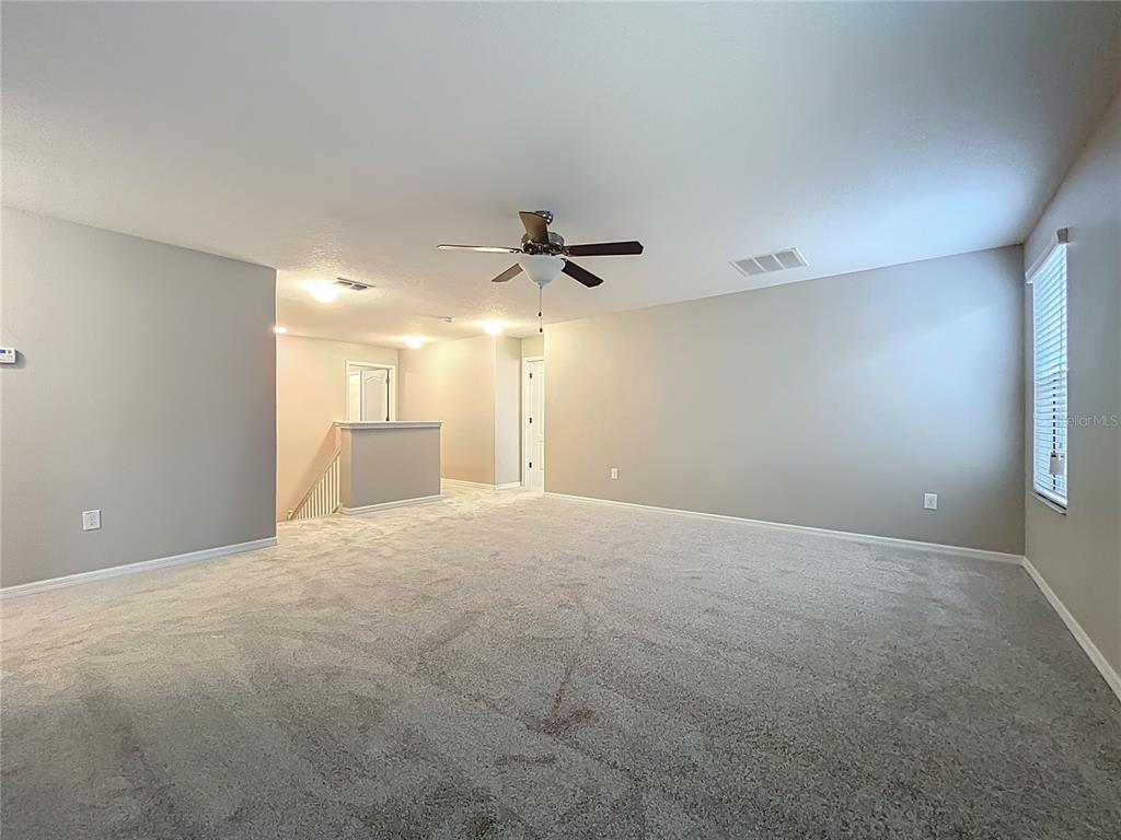 14240 Blue Dasher Drive Riverview, FL 33569 - Photo 39 of 66 a view of a livingroom with a ceiling fan and window