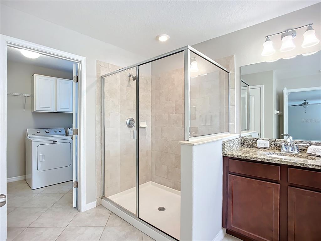 14240 Blue Dasher Drive Riverview, FL 33569 - Photo 46 of 66 a bathroom with a shower sink and mirror