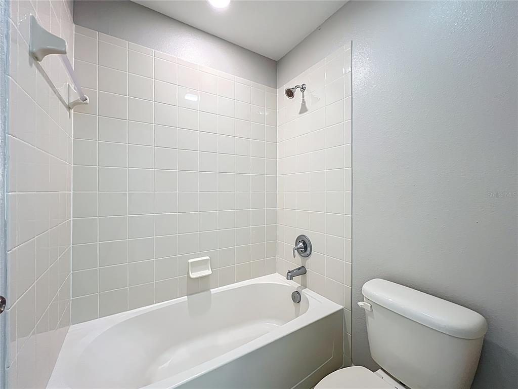 14240 Blue Dasher Drive Riverview, FL 33569 - Photo 55 of 66 a bathroom with a toilet bathtub and shower