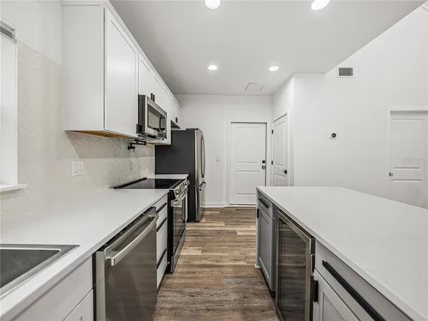 a kitchen that has a sink and a stove in it