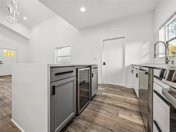a kitchen with a sink and a stove top oven