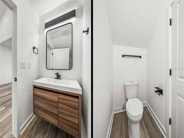 a bathroom with a sink a toilet and a mirror