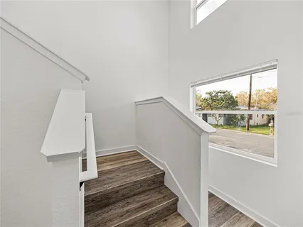 a view of a room with wooden floor and white walls