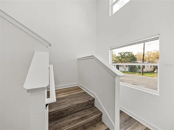 a view of a room with wooden floor and white walls