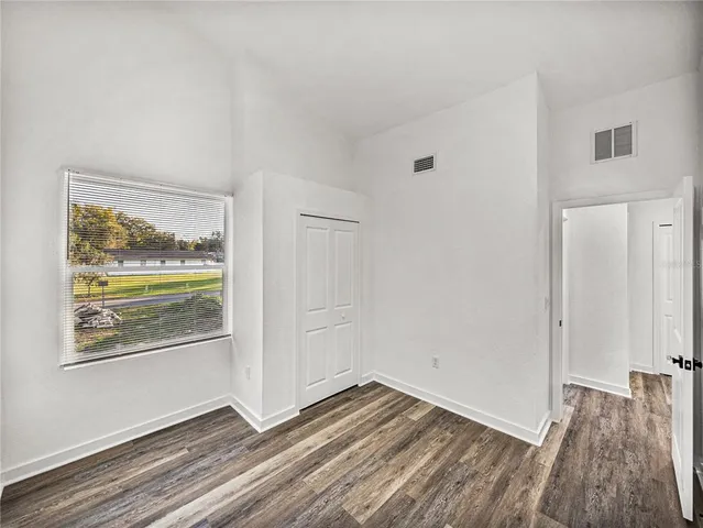 a view of a room with wooden floor and window