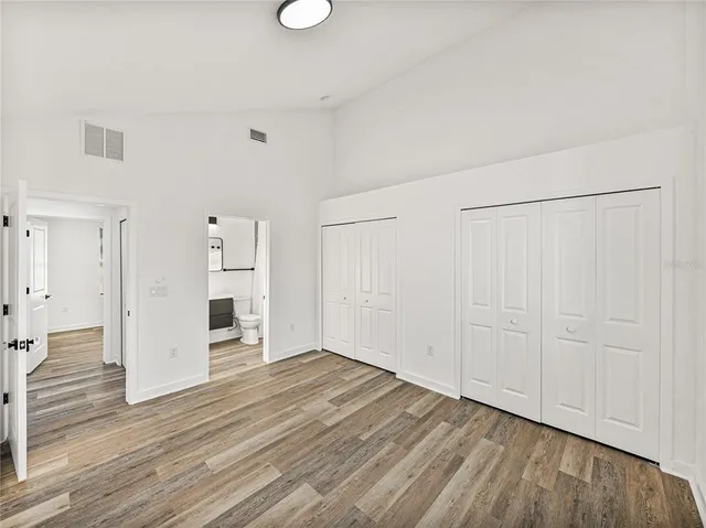 a view of empty room with wooden floor