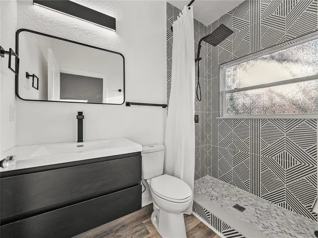 a bathroom with a toilet a sink and a mirror