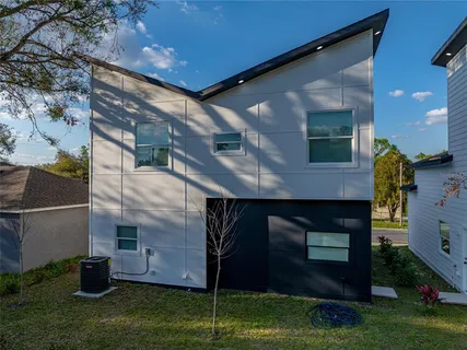 an aerial view of a house with a yard basket ball court and outdoor seating