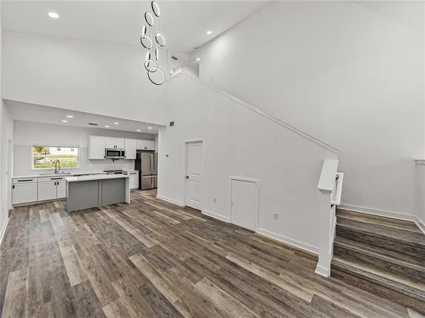 a view of a kitchen with a sink and wooden floor