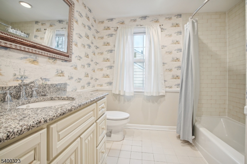 49 Madison Avenue Summit, NJ 07901 - Photo 13 of 15 a bathroom with a granite countertop sink a toilet and shower