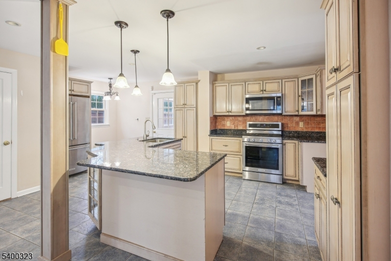 49 Madison Avenue Summit, NJ 07901 - Photo 3 of 15 a kitchen with kitchen island granite countertop a sink and stainless steel appliances