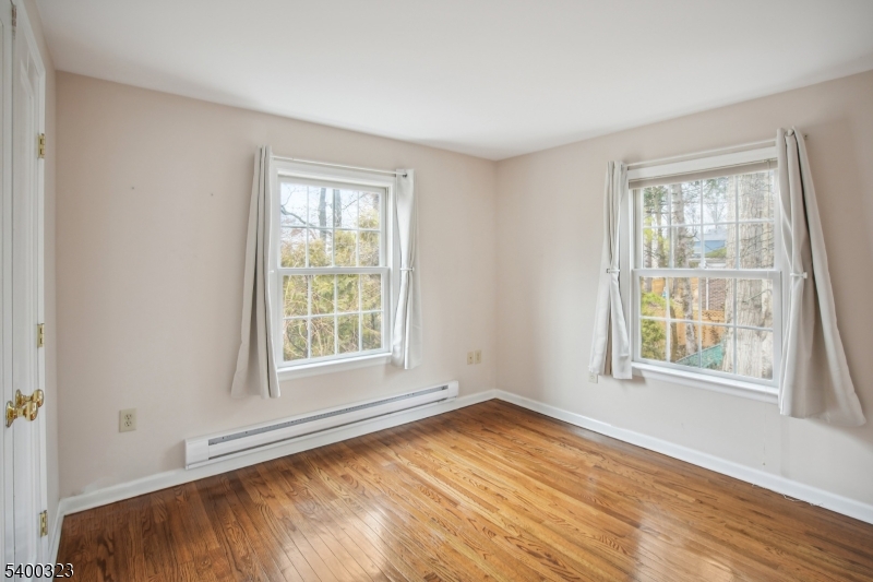 49 Madison Avenue Summit, NJ 07901 - Photo 5 of 15 an empty room with wooden floor and windows