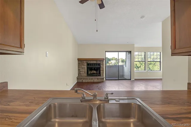 an empty room with floor to ceiling window and fireplace
