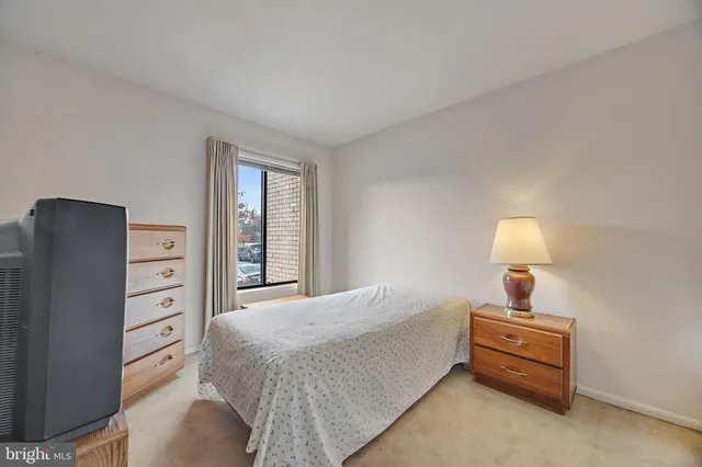 a bedroom with a bed and a television