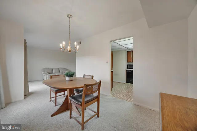 a view of a dining room with a table and chairs