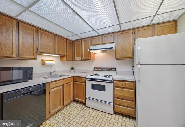 a kitchen with a sink a stove and refrigerator