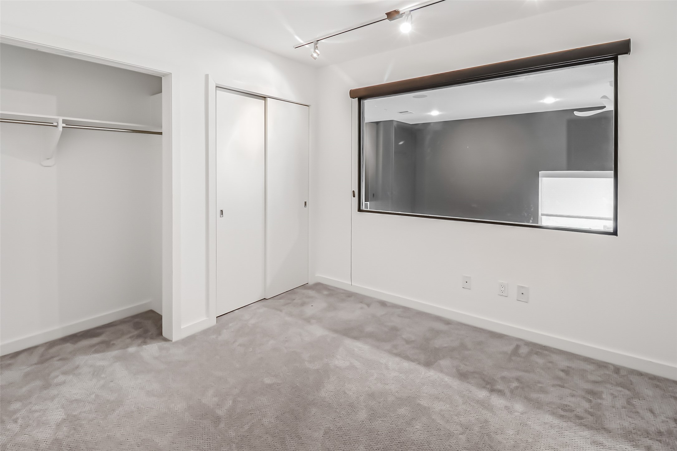 102 Quitman Street, Unit 301 Houston, TX 77009 - Photo 14 of 33 a view of an empty room with wooden floor and a mirror