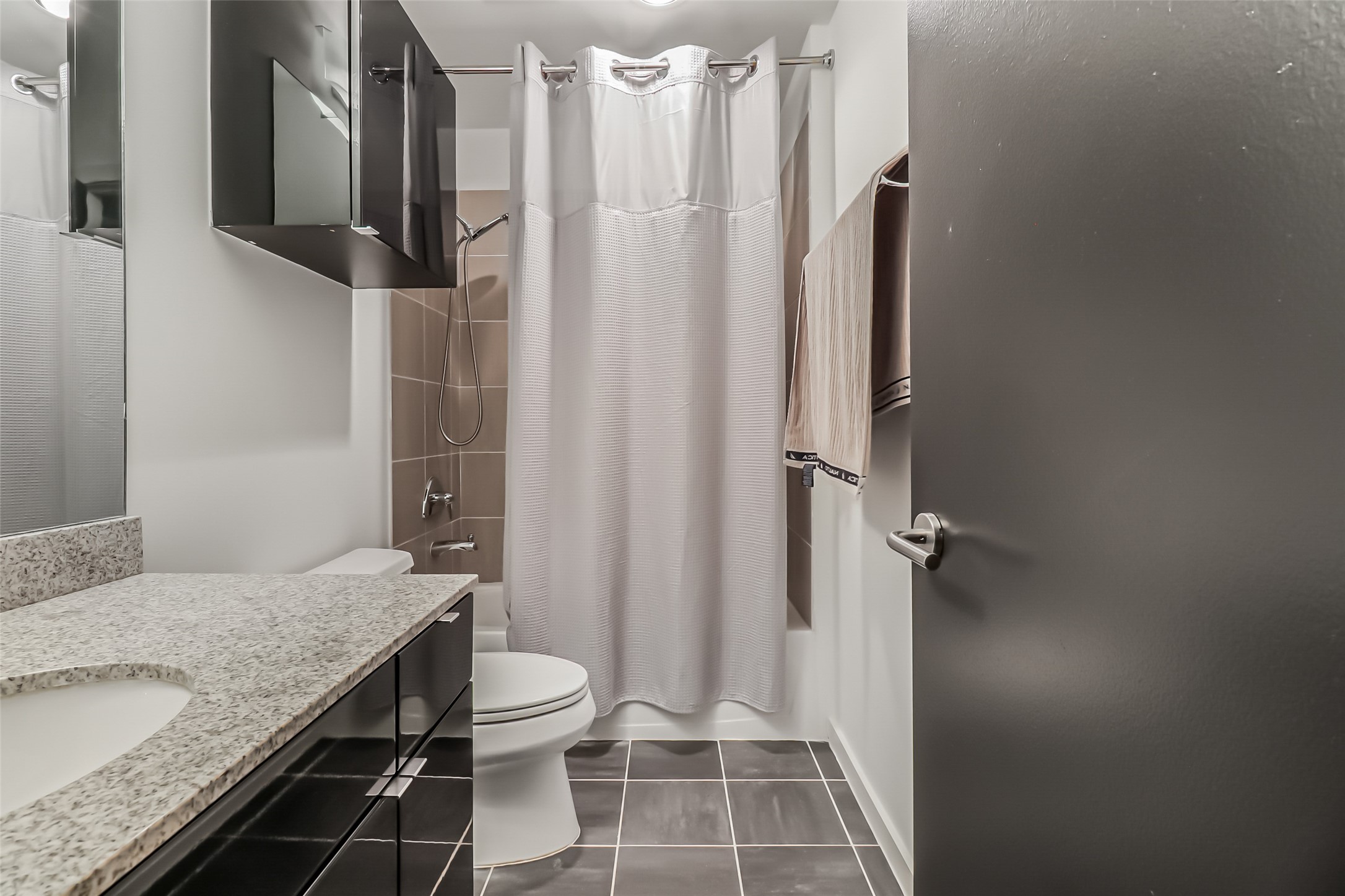 102 Quitman Street, Unit 301 Houston, TX 77009 - Photo 15 of 33 a bathroom with a granite countertop sink toilet and shower