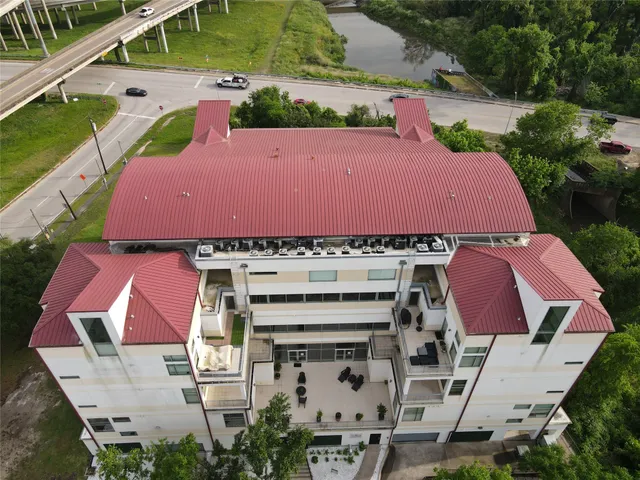 an aerial view of multiple houses with yard