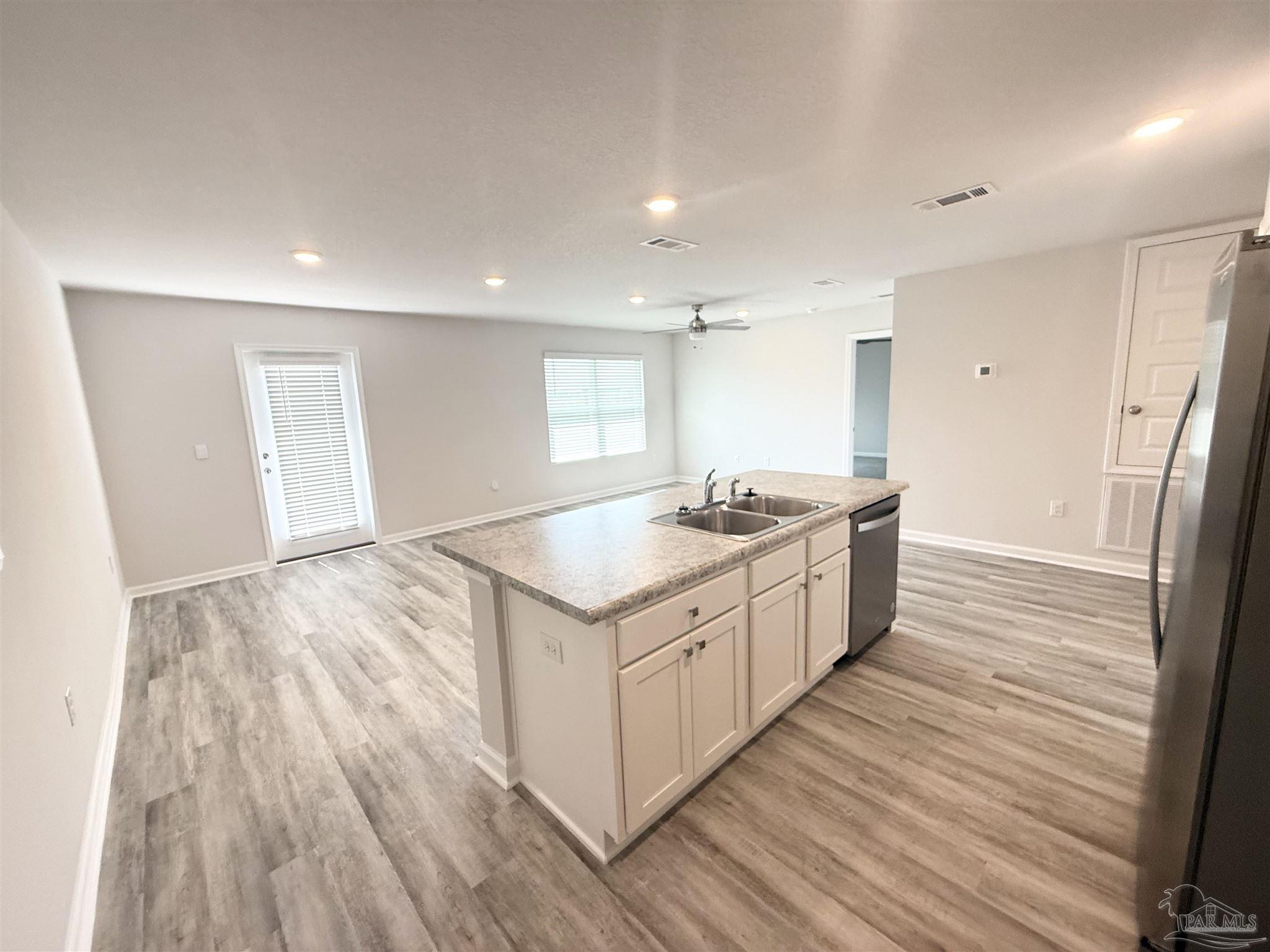 4335 Redbay Court Pace, FL 32571 - Photo 11 of 30 a kitchen with a sink and wooden floor