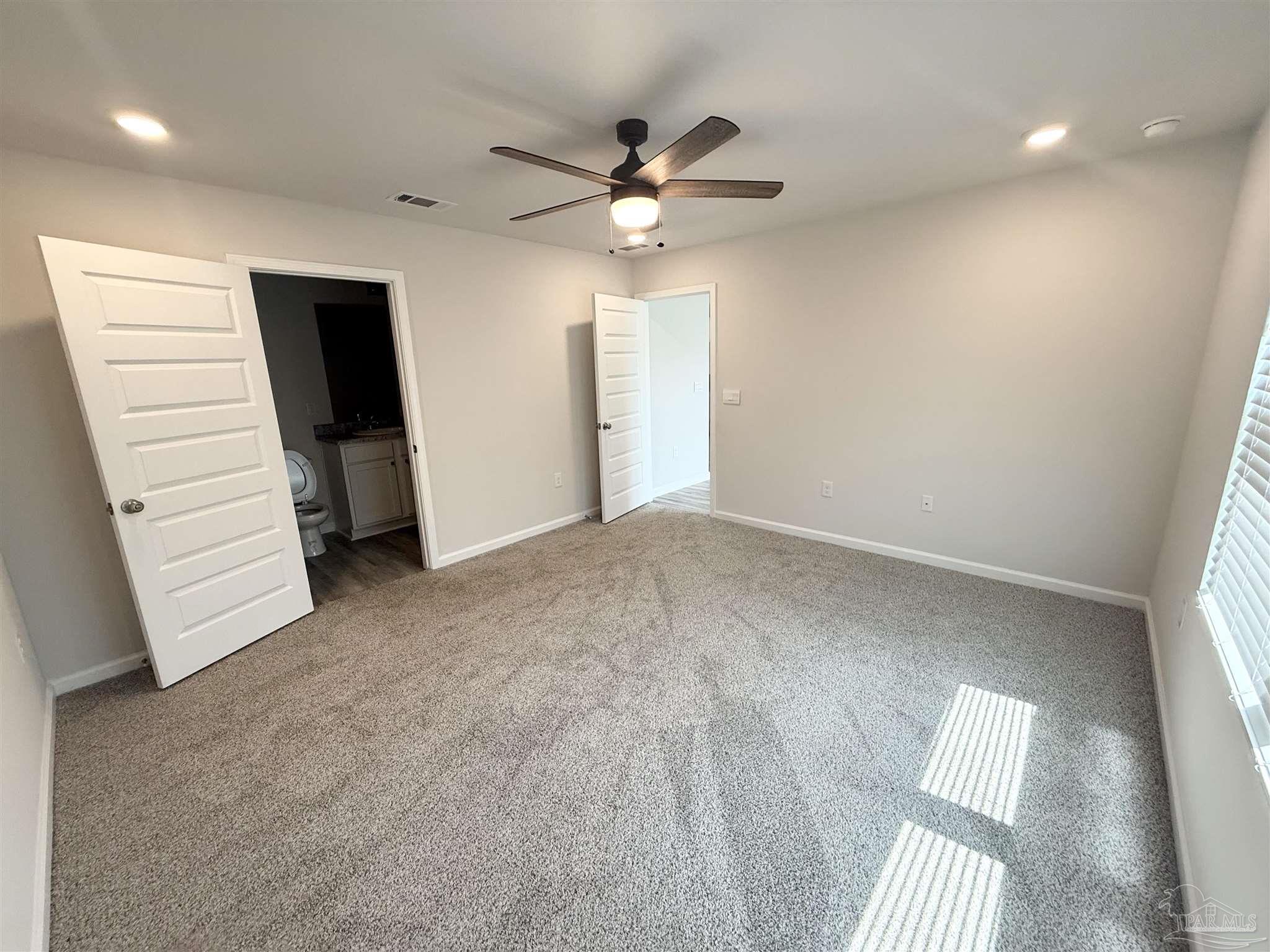 4335 Redbay Court Pace, FL 32571 - Photo 16 of 30 wooden floor in an empty room with a window