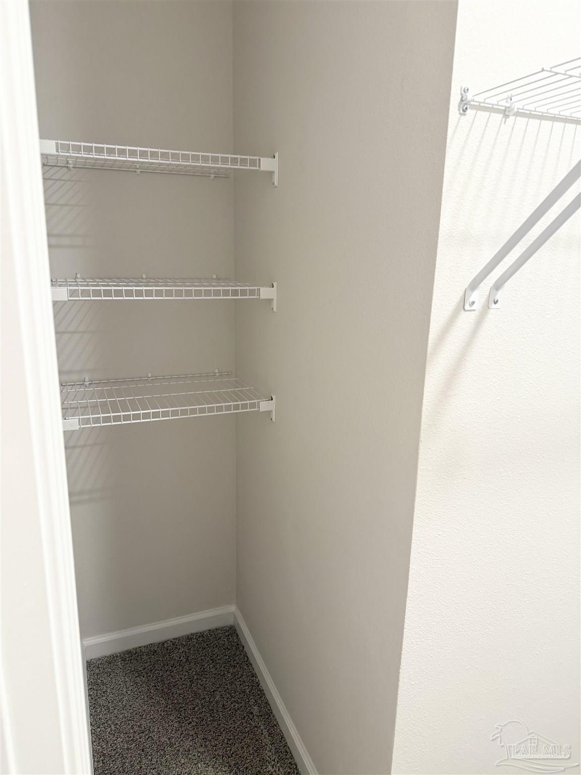 4335 Redbay Court Pace, FL 32571 - Photo 22 of 30 a view of a room with racks on the wall